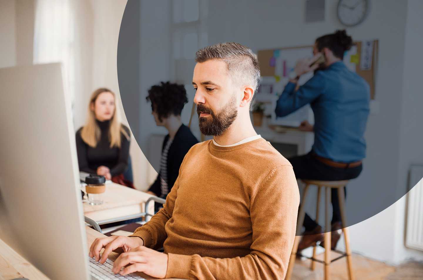 a man sitting at a desk on the computer