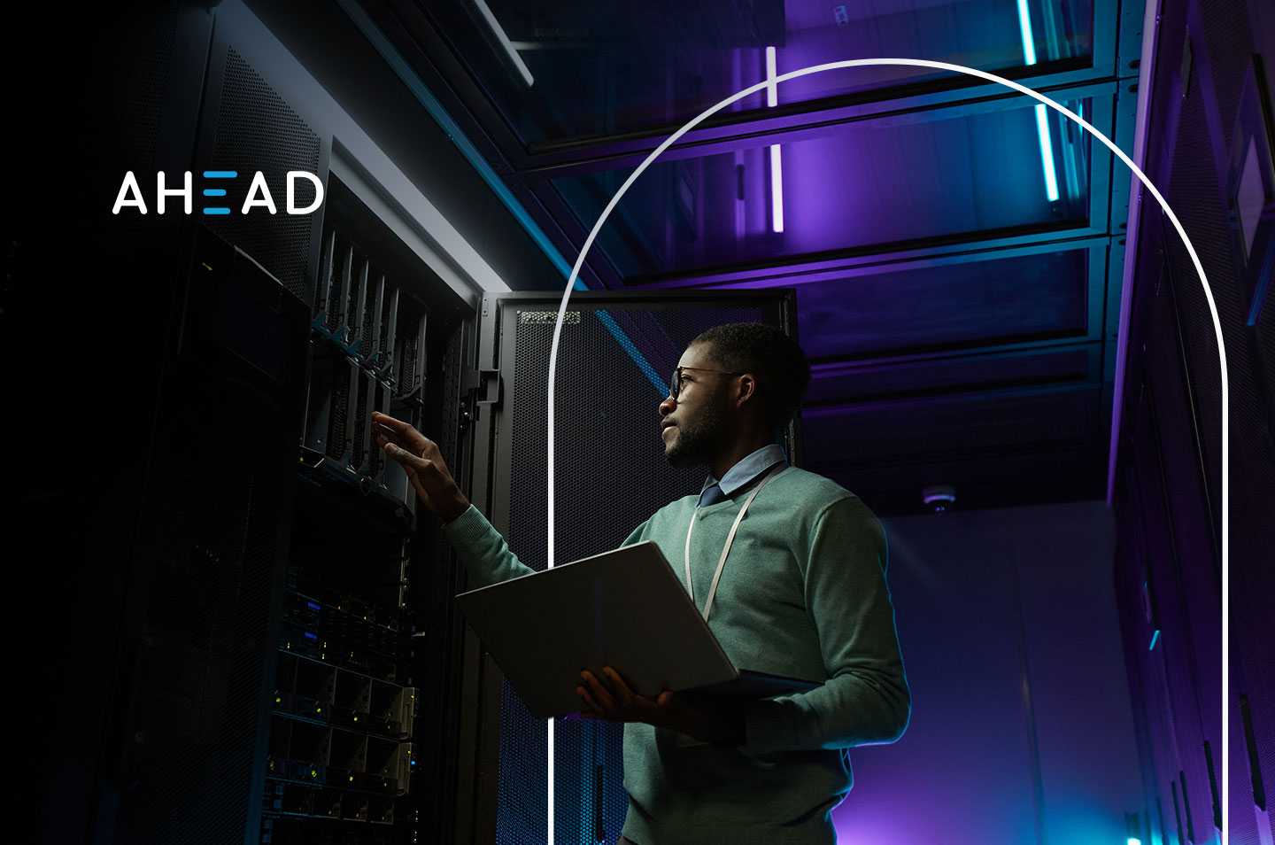 a man standing inside a data center looking at a rack