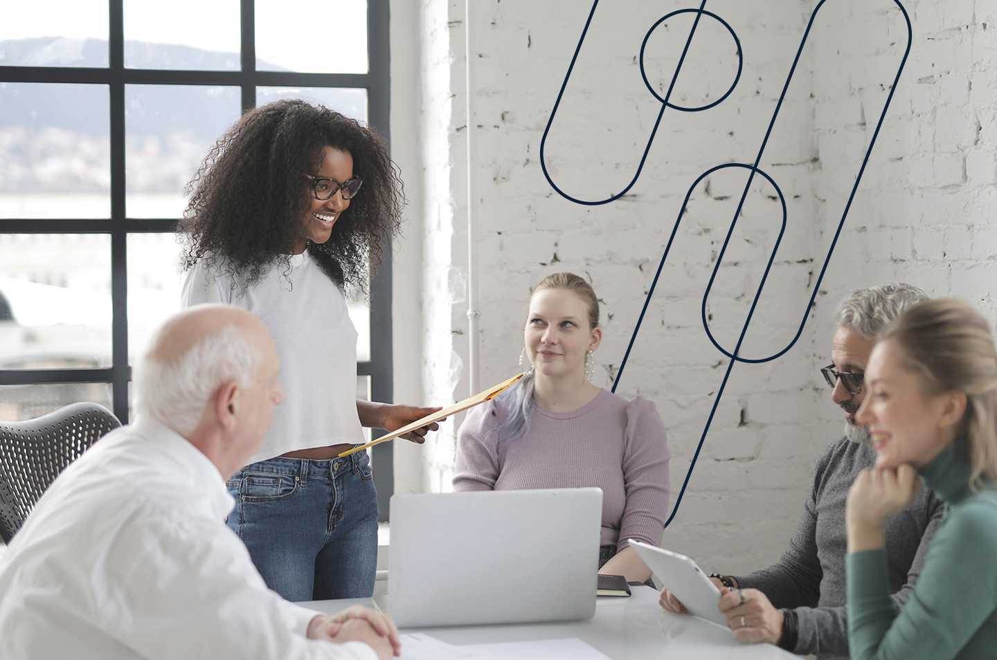 a group of people sitting around a table with one woman standing up